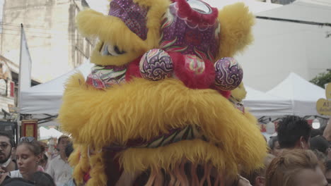 Chinese-New-Year-celebrating-in-Chinatown-Bangkok,-Thailand---traditional-Dragon-dance-on-the-street-in-Chinatown---People-wearing-masks-because-of-the-new-corona-virus-outbreak---Close-up---Editorial