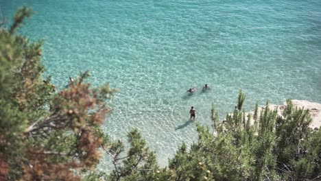Friends-in-Ibiza-sea-bathing-in-a-clear-water-in-Summer