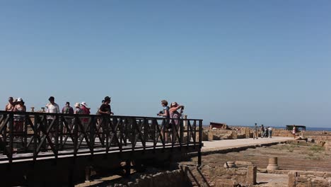 Tourists-walking-around-Paphos-Archaeological-park-and-taking-photos