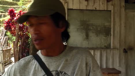 An-interview-of-a-native-man-wearing-a-cap-in-a-house-in-Batad,-Ifugao,-Philippines