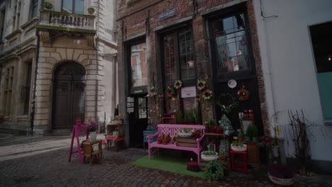 Cobblestone-Backstreet-Curiosity-Shop-with-Pink-Bench-Outside,-Antwerp