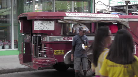 Iconic-red-jeepney-waiting-for-passengers-in-Olongapo-City,-Philippines