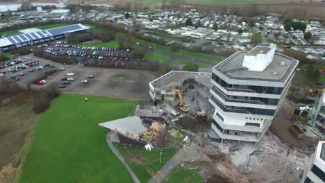 Drone-flying-towards-demolition-site-tilting-to-top-down-shot