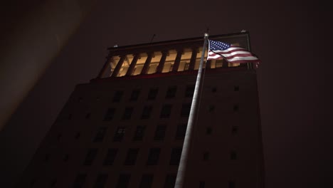 American-Flag-Flying-Outside-of-Saint-Louis-City,-22nd-Judicial-Circuit-Court-at-Night