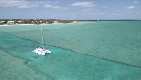 Ocean-Catamaran-Sailboat-on-Tropical-Sea-of-Bahamas,-Aerial-Drone-View
