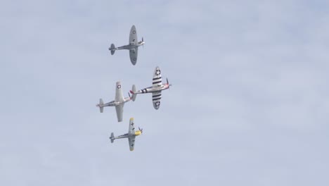 P-fifty-one-Mustang,-Spitfire,-Japanese-Zero,-and-Messerschmitt-Bf-Banking-While-Flying-in-Unison