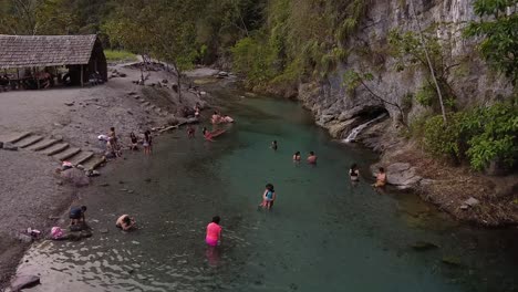 tourists-swimming,-relaxing-and-enjoying-in-Pozuzo-turquoise-natural-pool,-Peru