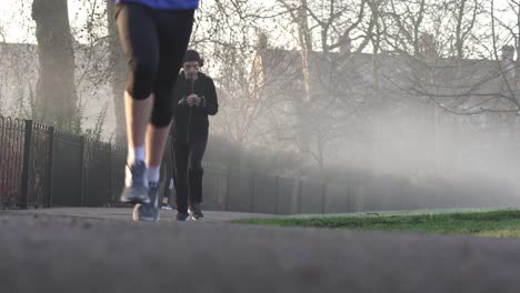 Three-men-are-running-in-the-park-in-the-early-cold-and-misty-morning