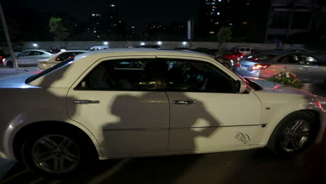 A-white-car-was-decorated-for-the-wedding-of-the-bride-and-groom-at-night