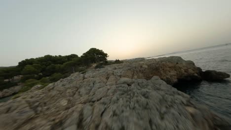 FPV-drone-view-over-coral-of-Cala-Punta-Negra-cove-in-Calviá,-Mallorca