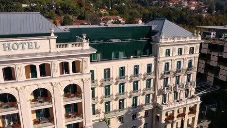 Forward-flying-drone-aerial-close-up-view-of-Trieste-Kempinski-palace-hotel,-Italy