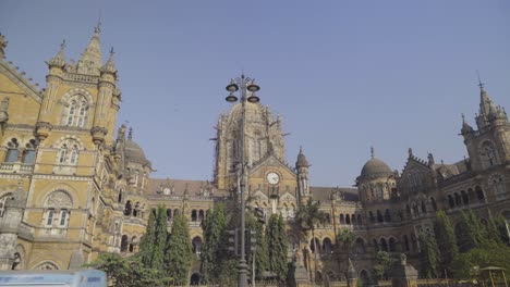 Traffic-across-streets-of-Chhatrapati-Shivaji-Maharaj-Terminus-station-with-the-view-of-the-iconic-building,-Mumbai,-India