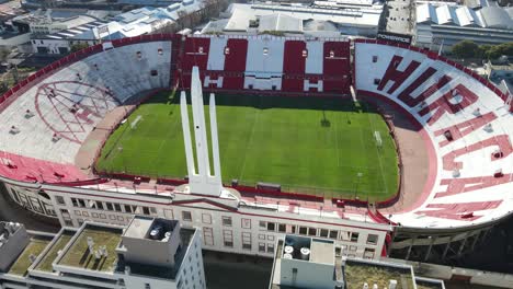 Aerial-circling-view-over-empty-tribunes-of-Huracan-football-club-stadium
