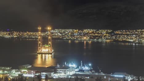 Time-lapse-of-The-heavy-lift-vessel-Gulliver-in-Tromso-Norway-getting-ready-to-haul-the-Russian-trawler-"Bukhta-Naezdnik"-up-from-the-sea-that-startet-to-burn-and-then-sunk