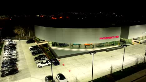 Porsche-Dealership-at-nighttime---aerial-flyover