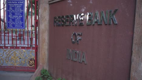 Reserve-Bank-of-India-RBI-logos-outside-of-RBI-building-at-Sansad-Marg,-Panning-right-shot