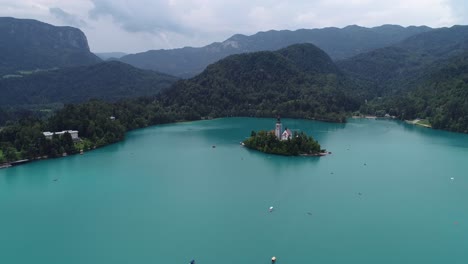 Drone-above-water-forward-flying-view-Bled-lake-island-church-in-summer