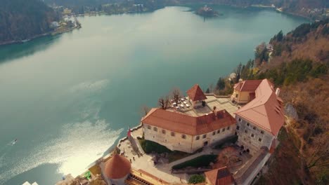 Drone-left-side-rotating-bird-eye-flying-view-of-lake-Bled-castle-on-cliff