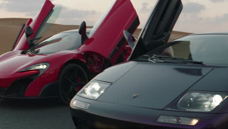 Close-up-shot-of-luxury-Lamborghini-and-Mclaren-Mercedes-in-sandy-desert-of-Dubai