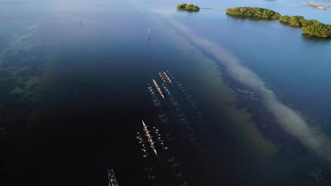 Aerial-Orbit-Shot-of-Rowing-Crew-at-Sunset