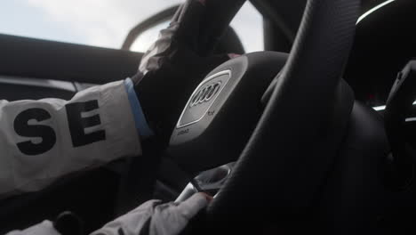 Close-Up-Of-Female-Hand-On-The-Steering-Wheel-Of-An-Audi-Car
