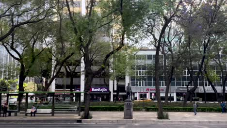 slow-motion-shot-of-paseo-de-la-reforma-avenue-and-a-demonstration-of-ayotzinapa-in-mexico-city