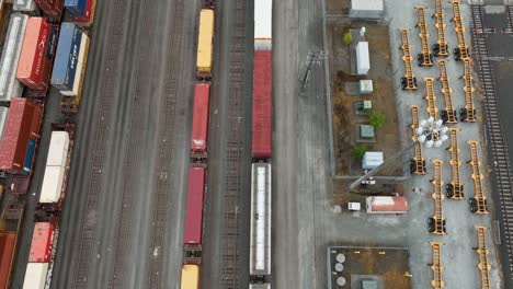 Overhead-aerial-view-of-a-slow-moving-train-with-shipping-containers-loaded-as-cargo