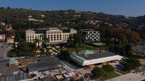 Forward-flying-drone-aerial-view-of-Trieste-Kempinski-palace-hotel,-Italy