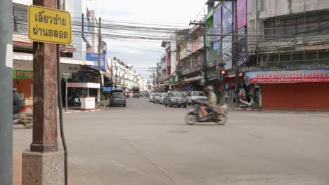 Shot-of-car-movement-along-the-road-crossing-in-Nan-city,-Thailand-on-a-cloudy-day
