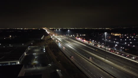 Aerial-forward-view-of-highway-with-cars-and-in-side-lane-firefighters'-vehicles-in-action