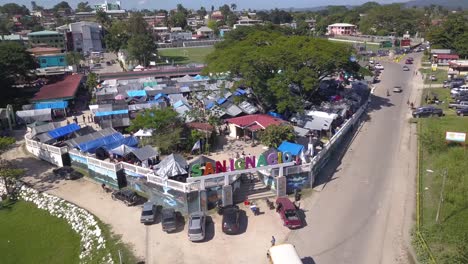 A-beautiful-drone-shot-looking-over-the-San-Ignacio-farmers-market-in-the-Cayo-District,-Belize-C