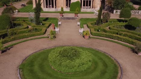 Aerial-shot-of-Manor-by-the-Lake-cheltenham-gloucestershire-reveal-of-house-from-the-gardens-in-morning-light