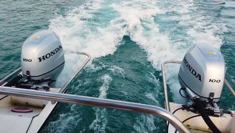 Shot-on-a-Honda-outboard-engine-of-a-small-motorboat-cruising-the-sea