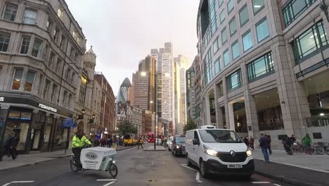 Timelapse-from-Bishopsgate-facing-the-city-of-London-at-rush-hour-in-a-busy-business-area-with-buses-and-bikes-at-sunset