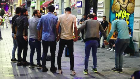 Group-of-young-modern-men-performing-folk-dance,-Dabke-on-the-street
