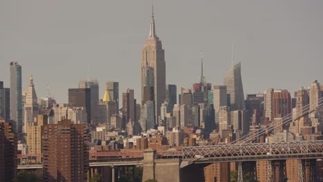 Cars-traffic-on-bridge-and-large-Empire-State-Building-in-New-York-in-background