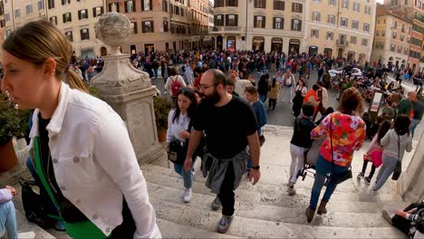 POV-walking-down-the-bottom-of-the-crowded-Spanish-Steps-in-Rome,-Italy
