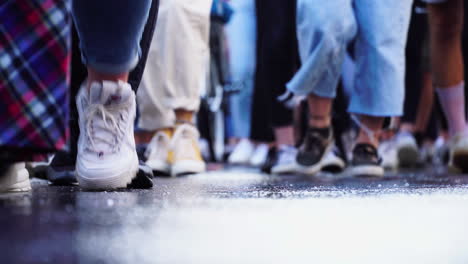 A-very-nice-shot-is-displaying-a-close-up-of-a-crowds-shoes-while-they-are-passing-the-camera