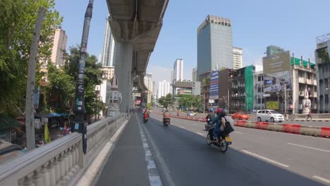 POV-move-along-pedestrian-alley-on-bridge-in-Bangkok-traffic-street