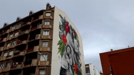 Colourful-graffiti-mural-depicting-illness-and-cancer-on-building-in-Aranda-de-Duero,-Burgos