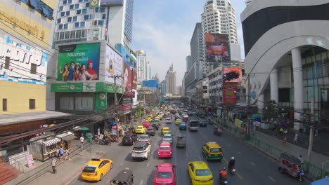 Busy-street-with-tall-office-buildings-and-electronic-billboards-around