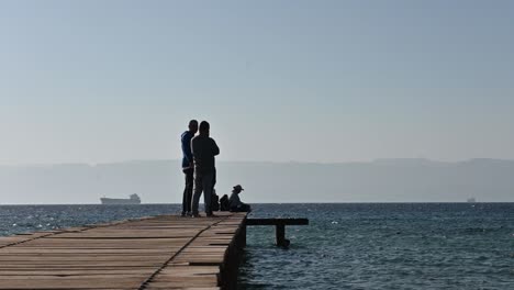 silhouette-of-men-on-the-jetty