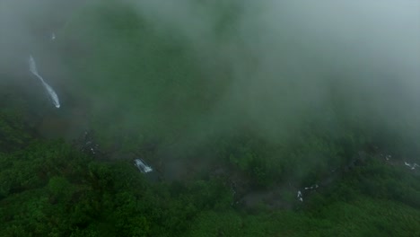 Aerial-view-of-nature-forest-waterfall-mist-fog-in-Vagamon-Kerala