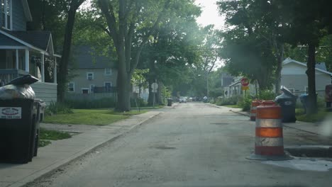 POV-Aus-Dem-Fenster,-Vorbei-An-Straßenarbeiten-Durch-Die-Nachbarschaft-In-Michigan