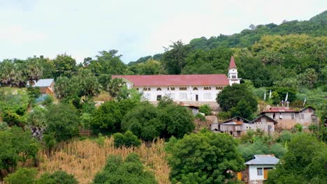 Beautiful-church-perched-on-the-hill-of-a-tropical-island-surrounded-by-green-trees-in-Alor-Island,-East-Nusa-Tenggara,-Indonesia
