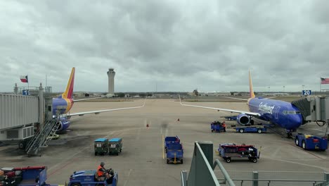 Airport-establishing-shot-on-a-cloudy-day-with-airplanes-in-foreground