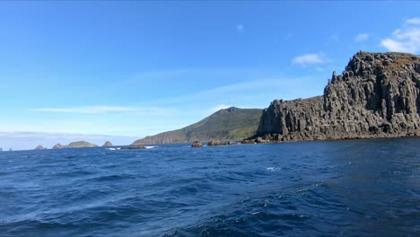 Bruny-Island,-Tasmania,-Australia---15-March-2019:-Fast-boat-powering-past-rocky-outcrops-on-Bruny-Island-Tasmania