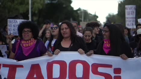 A-group-of-women-hold-a-banner-in-a-peaceful-protest-against-inequality