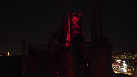 An-aerial-view-of-the-Bethlehem-Steel-stacks-lit-in-red-at-night