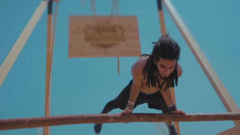 hippie-Athlete-flipping-playfully-on-a-wooden-bar-by-the-beach---Slow-Motion